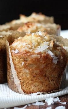 muffins with coconut on top sitting on a napkin