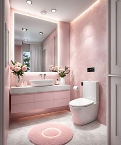 a bathroom with pink walls and flooring has a round rug on the floor next to the toilet