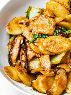 a white bowl filled with meat and vegetables