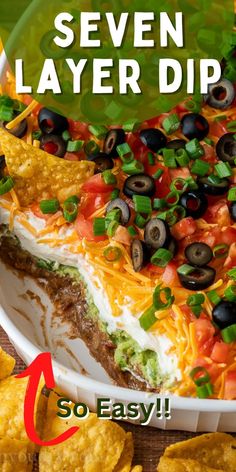 the seven layer dip has been made with tortilla chips and black olives