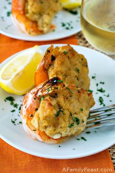 baked stuffed shrimp on a plate with lemon wedges