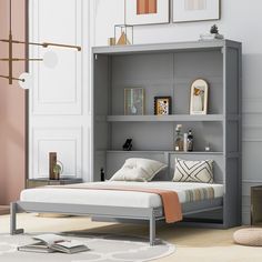 a bed sitting in front of a gray book shelf