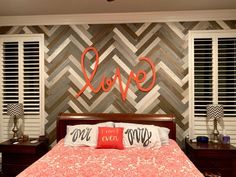 a bed room with a neatly made bed and wooden shutters on the wall behind it