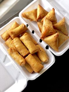 several trays filled with food sitting on top of a table