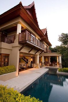 a large house with a pool in front of it