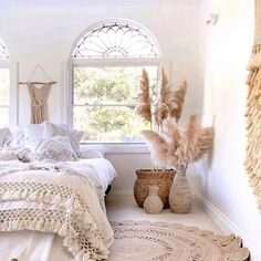 a bedroom with white walls and flooring is decorated in natural materials such as rugs