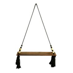 a wooden shelf with tassels hanging from it's sides on a string