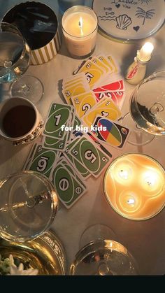 a table topped with candles and plates covered in cards