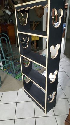 a mickey mouse shoe rack on the floor