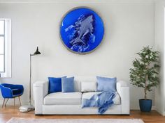 a living room with a white couch and blue pillows