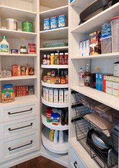 an organized pantry with white shelving and lots of food on the shelves, along with other items