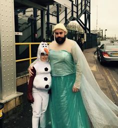 a man and woman dressed up as frozen princess and snowman standing next to each other