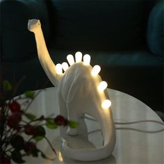 an elephant figurine with lights on it's trunk sitting on a table