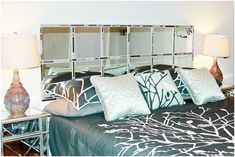 a black and white bed topped with lots of pillows