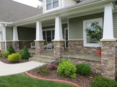 front porch with stone pillars and landscaping