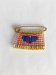 a red, white and blue pin sitting on top of a table