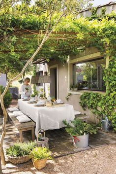 an outdoor dining area with table and chairs