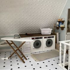 a laundry room with an ironing board and washing machine