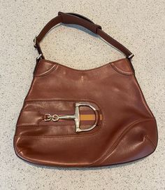 This classic Gucci Web Horsebit Hobo purse is brown leather with a great horsebit feature on the front. The leather strap measures 16 inches. The purse measures 13 1/2 x 10 1/2 inches. The interior of the purse is in pristine condition. There are a few small marks on the front of the purse- see photos. No dust bag, cards or receipt available. Please go to my shop- Carter Jewelry22- for more fabulous vintage and antique pieces! Also follow me on Instagram at CarterJewelry. Travel Satchel Shoulder Bag With Horsebit Detail, Travel Shoulder Bag With Horsebit Detail Satchel, Everyday Satchel Shoulder Bag With Horsebit Detail, Office Shoulder Bag With Horsebit Detail, Brown Rectangular Shoulder Bag With Horsebit Detail, Rectangular Brown Shoulder Bag With Horsebit Detail, Brown Shoulder Bag With Horsebit Detail, Office Satchel Shoulder Bag With Horsebit Detail, Brown Horsebit Shoulder Bag