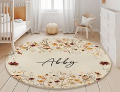 a baby's room with a flowery rug and crib in the background