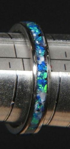 This is one of my newest creations and i'm very proud of how it looks. This ring is a size 9 but I can duplicate it in your size. Made on a  4mm stainless  ring blank with a 2mm inlay channel.  The inlay is different shades of blue  crushed opel,  all sealed in a clear resin and lathe turned, sanded and polished. this ring pictured is a size 9. Other sizes can be substituted for my chosen ring. Free shipping and ring presentation box included. Blue Crush, Ring Pictures, Christmas Deals, Clear Resin, Shades Of Blue, Favorite Jewelry, Band Rings, Hand Made, Jewelry Rings