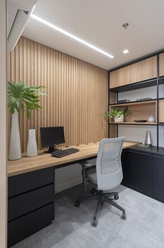 an office with a desk, computer and shelves on the wall next to each other