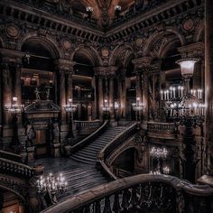 an ornate building with chandeliers and stairs