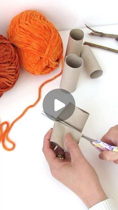 someone is doing something with yarn and scissors