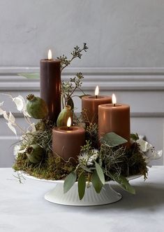 a magazine cover with candles and flowers in it's centerpiece on a table