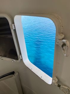 an airplane window looking out at the ocean