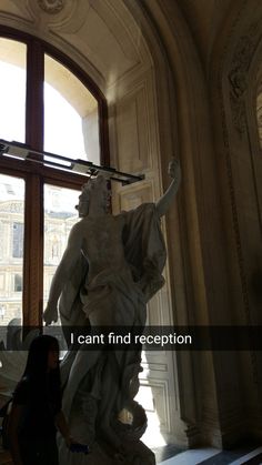 a woman standing in front of a statue with the words now let me take a selfie