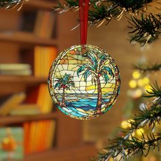 a stained glass ornament hanging from a christmas tree with bookshelves in the background