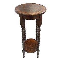 an old wooden table with two legs and a small round shelf on the top that is turned upside down