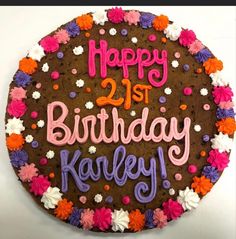 a birthday cake with the words happy 21st birthday kaley written in pink and purple frosting