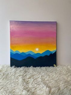 an acrylic painting of mountains in the sunset