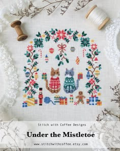 a cross stitch pattern with the words under the mistcote on it and two spools of thread next to it