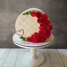 a heart shaped cake with roses on top