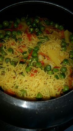 peas and cheese are being cooked in a pan