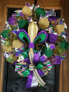 a purple, green and gold wreath on a door