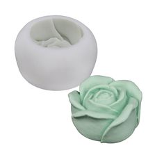 two white and green flower shaped soaps on top of each other, one with a rose in the middle