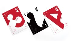 two playing cards, one red and one white with the letter q on it's side