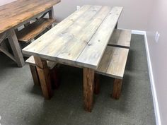 a wooden table and benches in a room