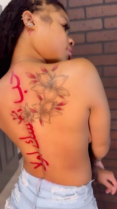 the back of a woman's body with flowers painted on her upper and lower half