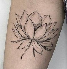 a black and white lotus flower tattoo on the right thigh, with an inner arm