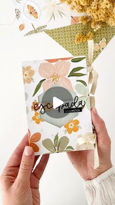 someone is holding up a card with the word, one baby on it and flowers