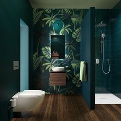 a bathroom with green and blue walls, wood flooring and a white toilet