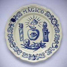 a blue and white plate with the words magic written in front of an apple on it