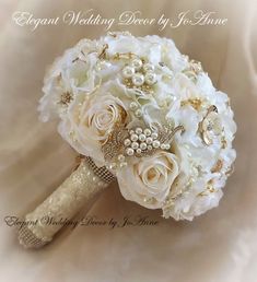 a bridal bouquet with white flowers and pearls