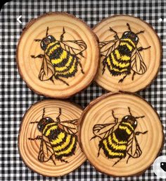 four bees on wooden slices with black and white checkered table cloth