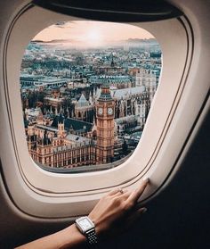 an airplane window with the view of london and big ben